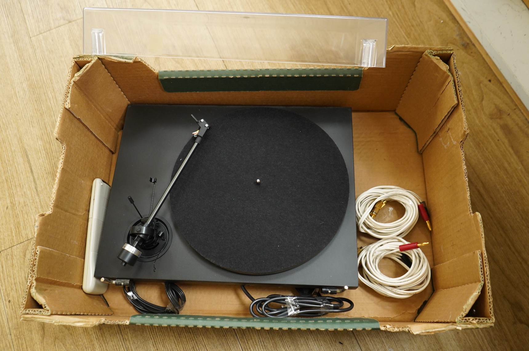 A collection of stereo equipment, including a Project P1 turntable record player, a Denon UPA-F10 integrated stereo amplifier with remote control, a boxed Kenwood KX-260 cassette tape player and a pair of Monitor Audio s